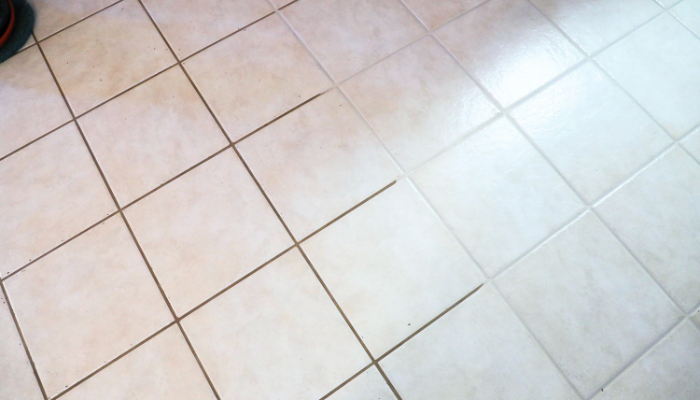 Light-colored ceramic tile floor with clean grout lines and a smooth, well-maintained surface. The image highlights the appearance of cleaned tile flooring.