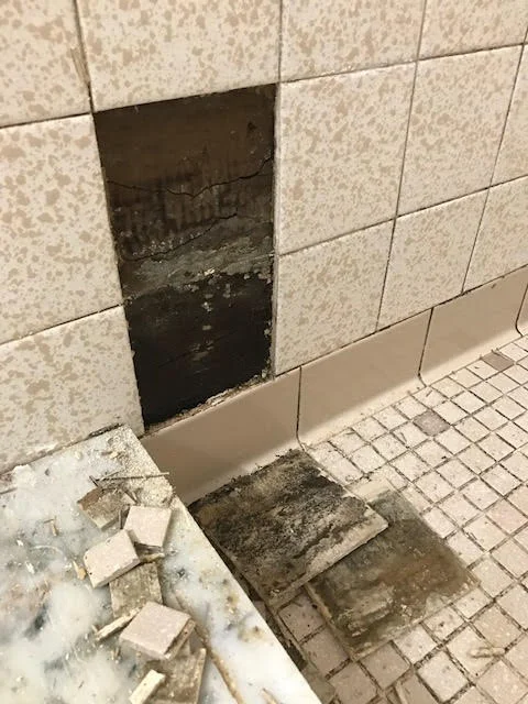 severe water damage in a tiled shower
